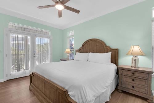 a bedroom with a large bed and a ceiling fan at Brzee Bungalow in Destin