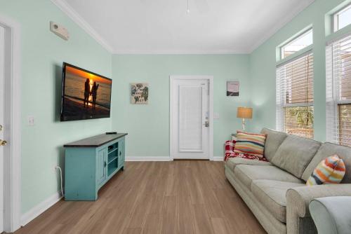 a living room with a couch and a tv at Brzee Bungalow in Destin