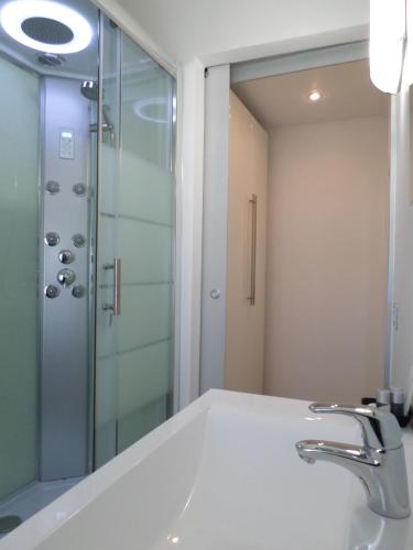 a bathroom with a sink and a shower at H5-5H Luxury Room in Maranello