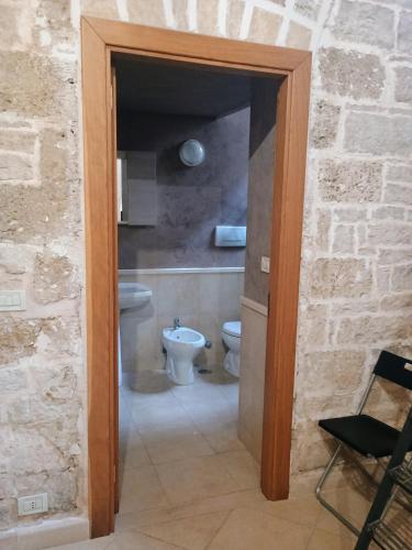 a bathroom with a toilet and a chair in it at INcentro in Bitonto