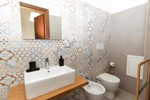 a bathroom with a white sink and a toilet at Palazzo Santori in Tivoli
