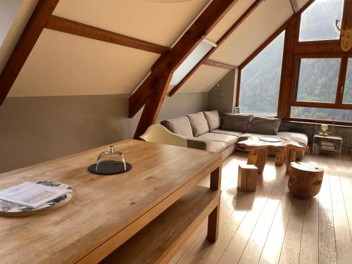 a living room with a table and a couch at Le petit Repaire de Sailhan, Ecolodges in Sailhan