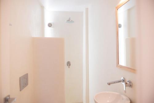 a bathroom with a sink and a mirror at The Summit of Mykonos in Kalo Livadi