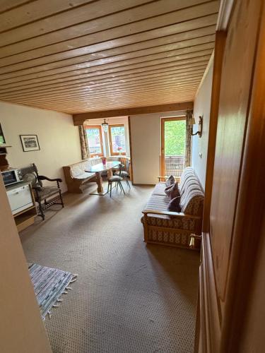 a living room with a couch and a table at Häusl am Roan Reutte Höfen in Hofen