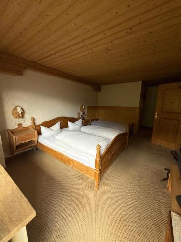 a bedroom with a wooden bed in a attic at Häusl am Roan Reutte Höfen in Hofen