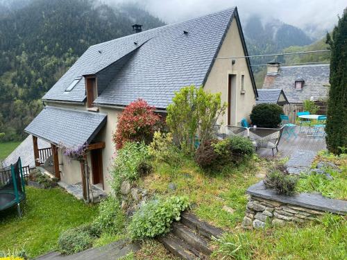 a small house with a porch and a patio at Le petit Repaire de Sailhan, Ecolodges in Sailhan
