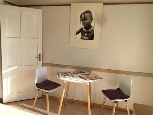 a room with a table and two chairs at Pianoforte holiday apartments in Swakopmund