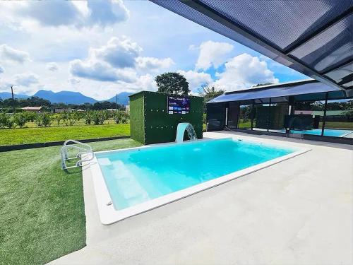 a large swimming pool in a yard next to a building at Casa Cristal # 1 in Fortuna