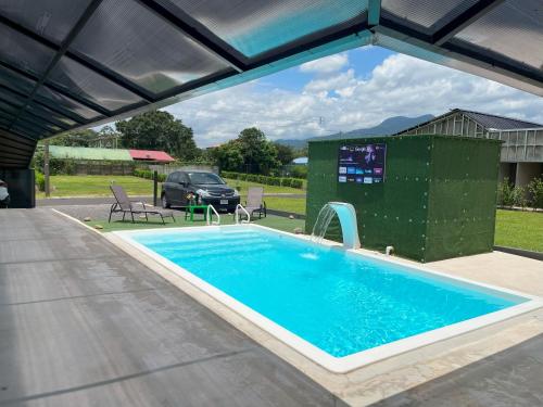 a large swimming pool with a water fountain at Casa Cristal # 1 in Fortuna