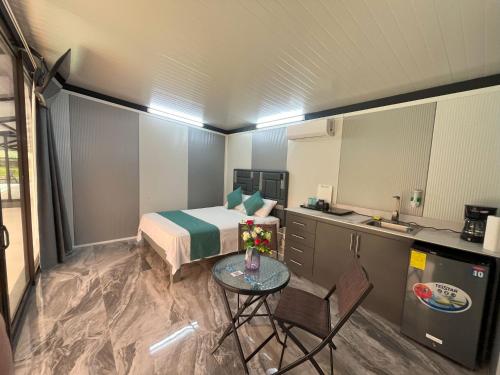 a bedroom with a bed and a table and a kitchen at Casa Cristal # 1 in Fortuna