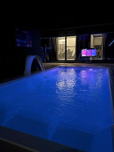 a swimming pool with a fountain in a building at Casa Cristal # 1 in Fortuna