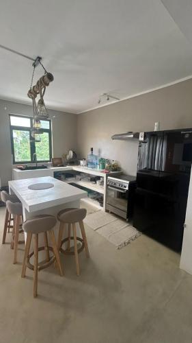 a kitchen with a table and some chairs in it at Gui Appartement in Midlands Station