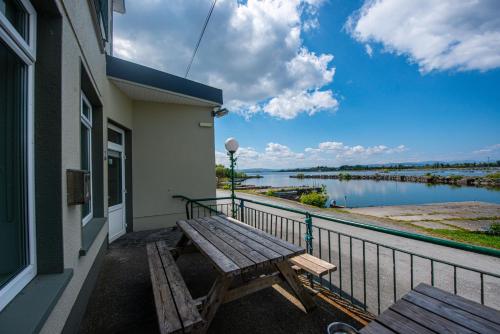 a balcony with a bench and a view of a river at Greenfield Lodge Hotel Bar & Bistro in Headford