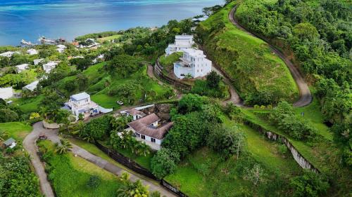 an aerial view of a house on a hill at Spectacular Luxury Rental With Ocean Views And Private Pool in Roatan