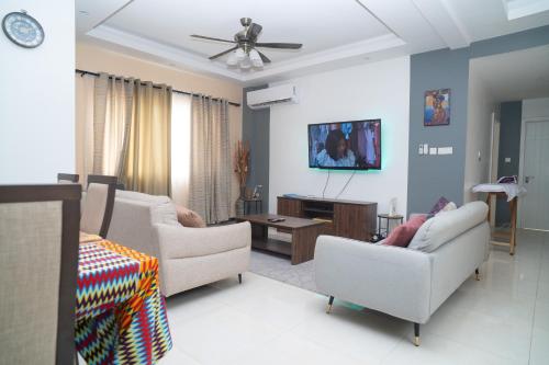 a living room with two chairs and a table at Ocean View Apartments in Sakumona
