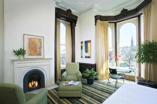 a living room with a fireplace and a couch at The Mansion on Delaware Avenue in Buffalo