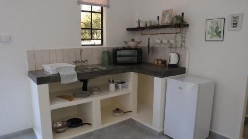 Kuchyň nebo kuchyňský kout v ubytování Acacia Cottage
