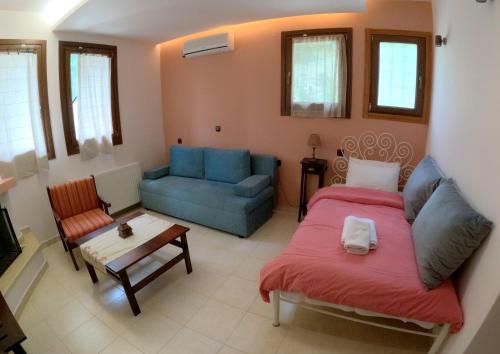a living room with a bed and a couch at RASTONI Pelion in Vizitsa