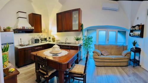 a kitchen with a couch and a table in a room at Casa Vacanze Raimonda in Nardò