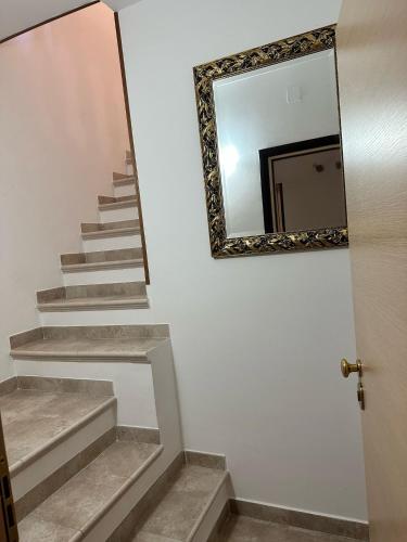 a mirror on a wall next to a stairway at B&B Casa Lulu' in Peschici