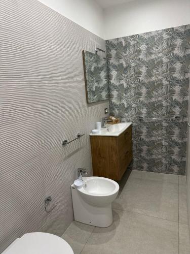 a bathroom with a toilet and a sink at B&B Casa Lulu' in Peschici
