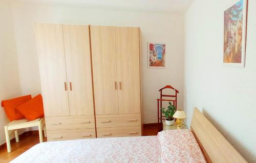 a bedroom with a large wooden cabinet next to a bed at La Terrazza in Barano d'Ischia