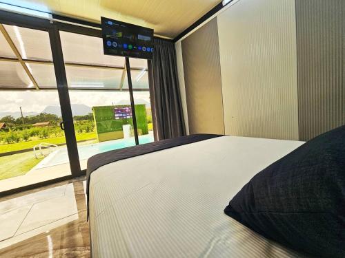 a bedroom with a bed and a large window at Casa Cristal # 1 in Fortuna