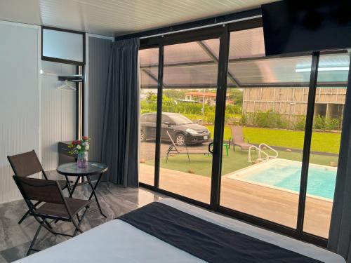 a bedroom with a bed and a view of a pool at Casa Cristal # 1 in Fortuna