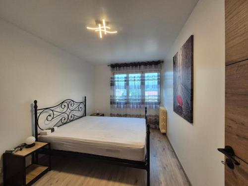 a bedroom with a bed and a cross on the wall at Le Bellevue in La Roche-sur-Yon