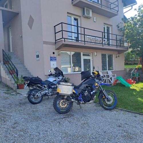 two motorcycles parked in front of a house at Apartment Beha in Bihać