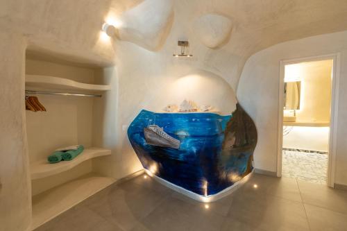 a room with a large aquarium in the corner at Rody Caves in Oia