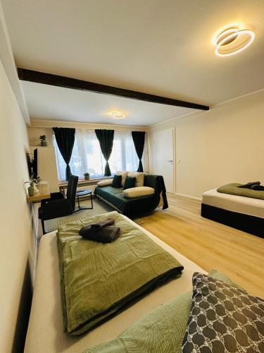 a living room with a bed and a couch at Schulz Apartments Siegburg in Siegburg