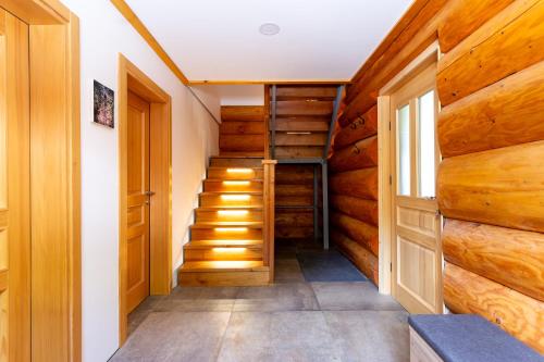 a hallway with wooden walls and stairs in a house at Villa Harmonia Private Jacuzzi and Pool Retreat near Rogaška in Rogatec