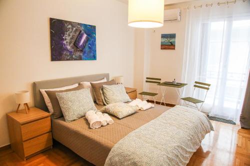 a bedroom with a bed with two stuffed animals on it at Plaka City Centre Athens Flat in Athens