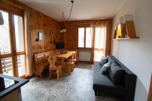 a living room with a couch and a table at Chalet Del Rio in Fiumalbo