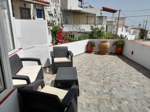 a patio with chairs and tables on a building at GIANNIS-KLEOPATRA HOUSE 1 in Kerames