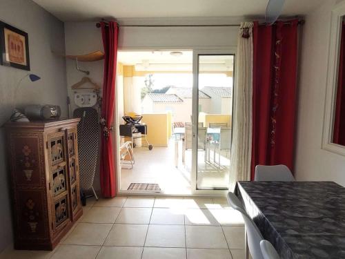 - un salon avec une porte s'ouvrant sur une terrasse dans l'établissement Appartement Duplex 3P, 6 Couchages, Proche Plage, Parking, Télévision, Balcon, Ménage Inclus - FR-1-251-722, au Lavandou