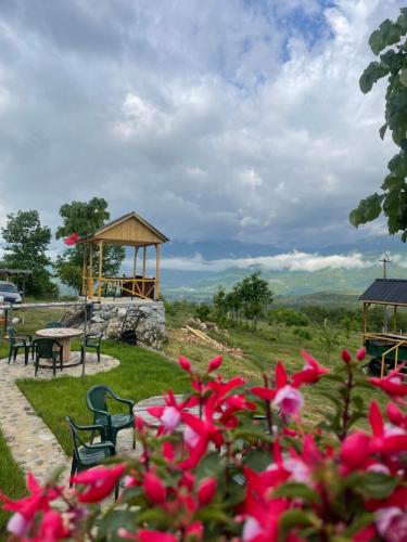 a park with a gazebo and pink flowers at Bujtina Spata guest house sleep quiet in Peshkopi