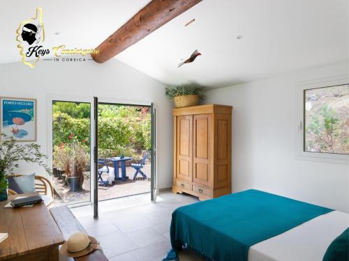 une chambre avec un lit, une table et une fenêtre dans l'établissement Villa Acciagina 10 pers PISCINE VUE MER PINARELLO Climatisée, à Pinarellu