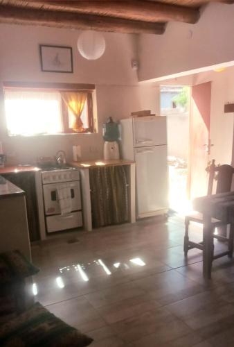a kitchen with a stove and a refrigerator at Cabaña colibrí in Maimará