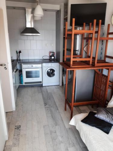 une petite cuisine avec une cuisinière et un micro-ondes dans l'établissement Ajaccio VUE MER IMPRENABLE 4a5 Pers, à Ajaccio