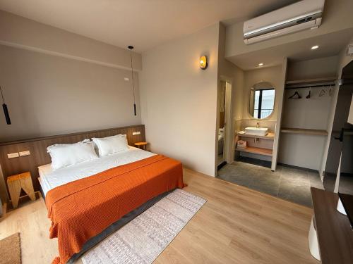 a bedroom with a bed and a bathroom with a sink at Brewstay in Luye
