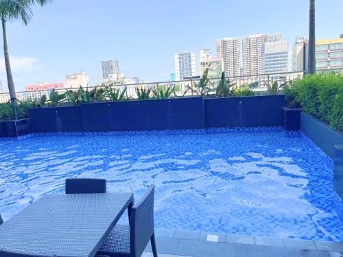 a swimming pool with a table on a building at Charlie's Staycation at Coast Residences in Manila