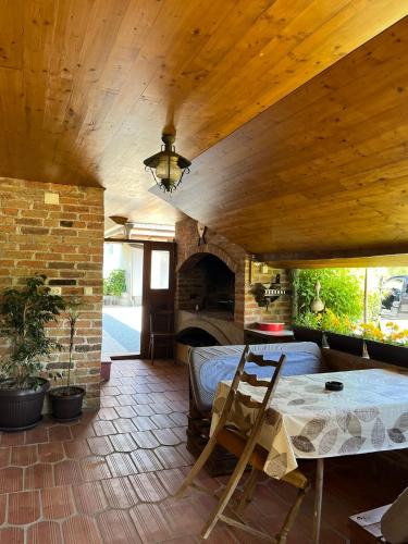 a living room with a table and a fireplace at Kuća za odmor Balog in Lipik