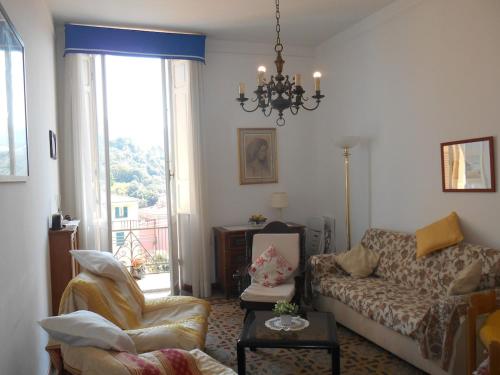 a living room with a couch and a chair at 50 m from the beach, Lerici-5 Terre, gulf view in Lerici