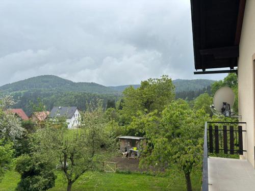 a view of a field with trees and a house at Ferienwohnung am Labyrinth in Semriach