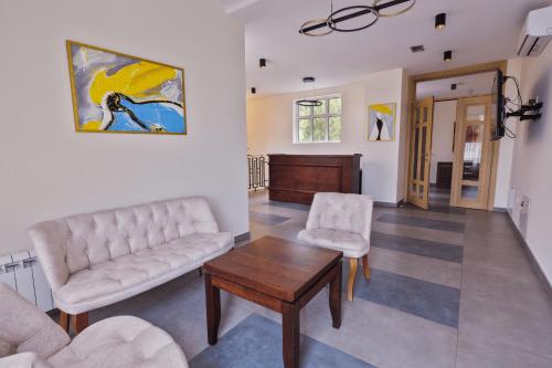 a living room with a couch and a table at Vinarija Aleksandrović Rooms in Topola