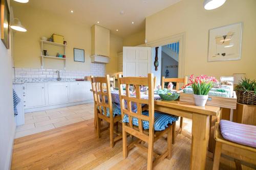 a kitchen and dining room with a table and chairs at The Coach House at Moyglare Manor in Maynooth