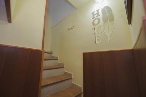 a stairway with a sign on the wall at Casa Lusa in Procida