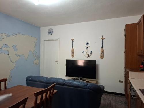 a living room with a blue couch and a flat screen tv at Pintadera in San Giovanni